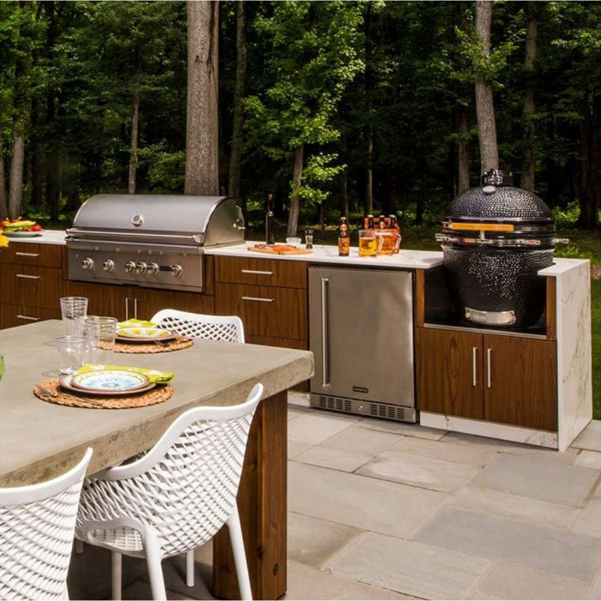 Coyote C1CHCS 22-inch black ceramic Kamado smoker with built-in charcoal chamber and ceramic construction for outdoor grilling.