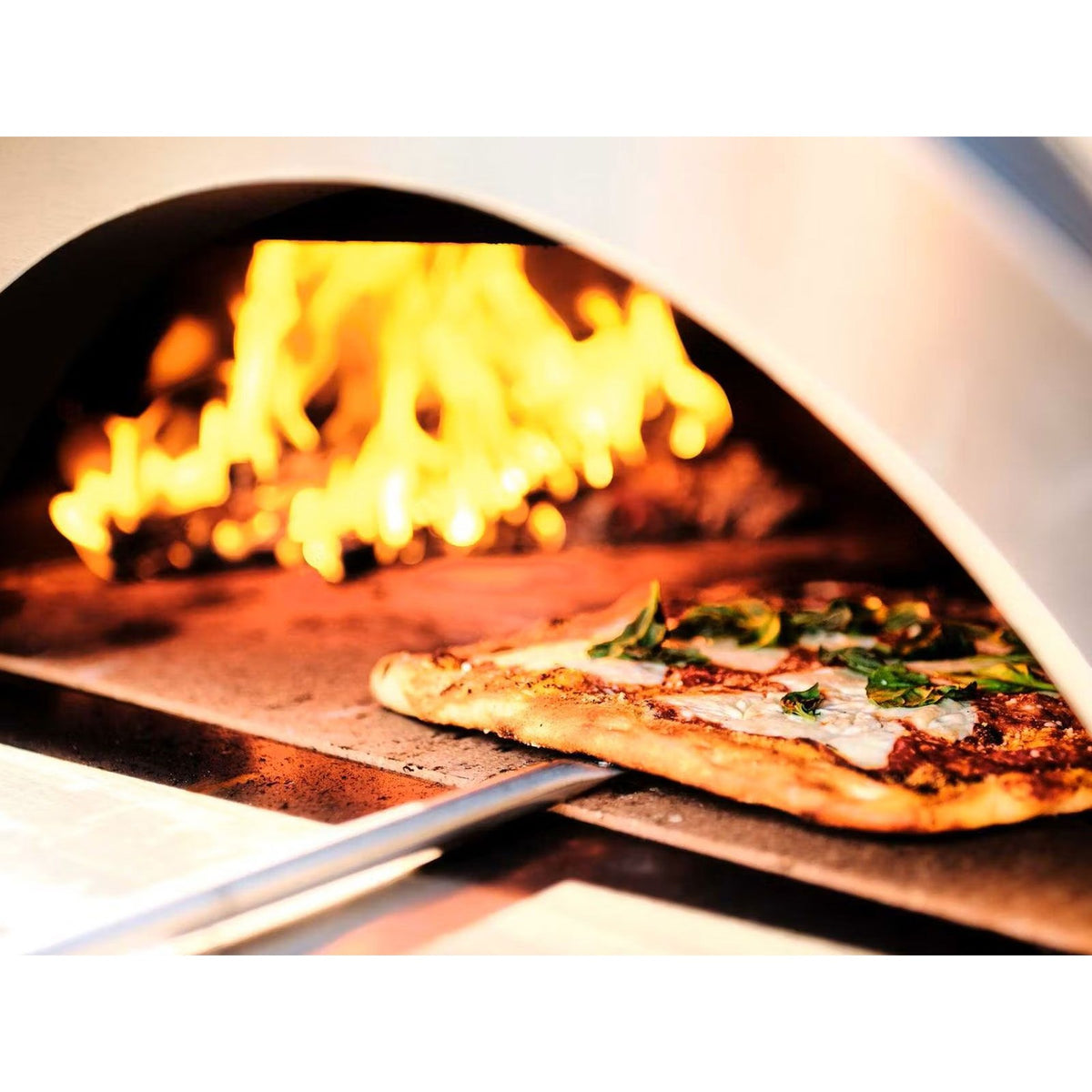 Coyote C1PZ40WY 40-inch yellow outdoor wood-fired pizza oven with stone interior and stainless steel accents.